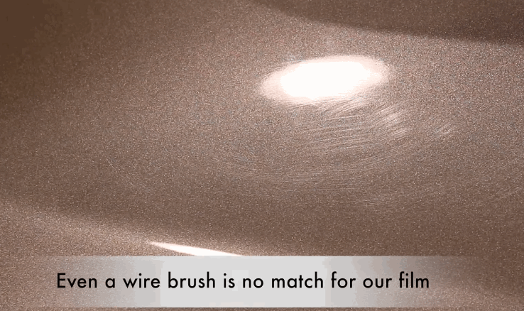 A close-up of a metallic painted surface showing scratches being self-healed by paint protection film